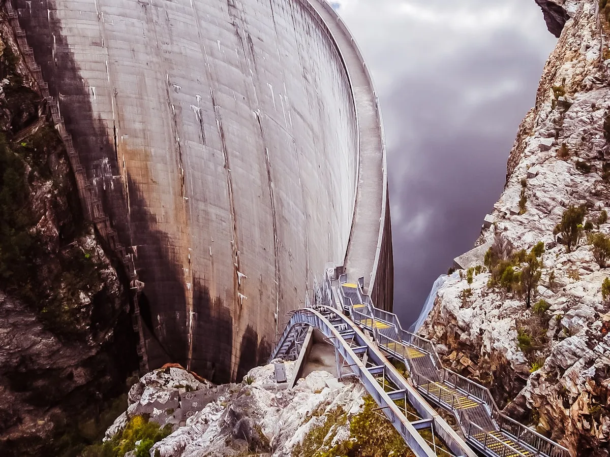 Concrete arch dam structure set into a steep rock gorge