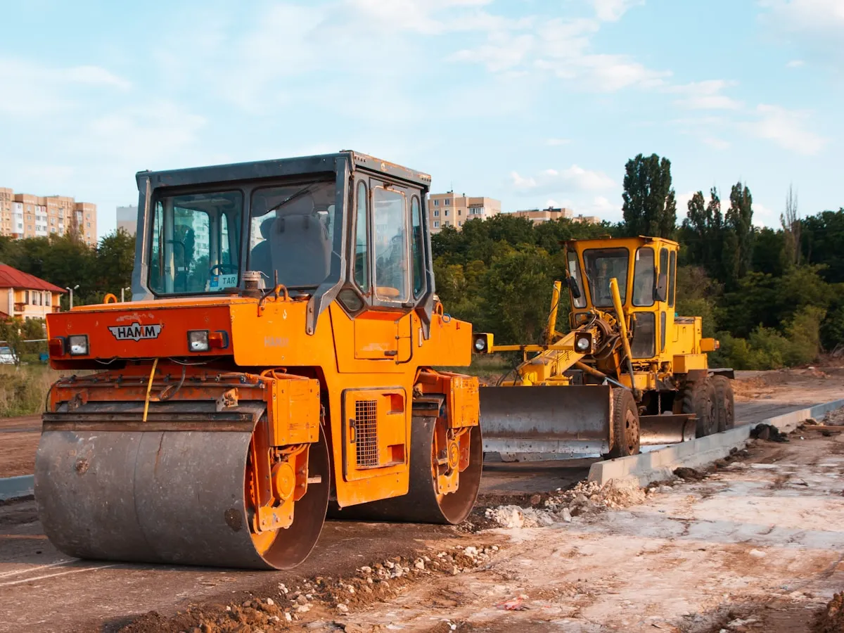 Road rollers and a grader working a highway sub-base