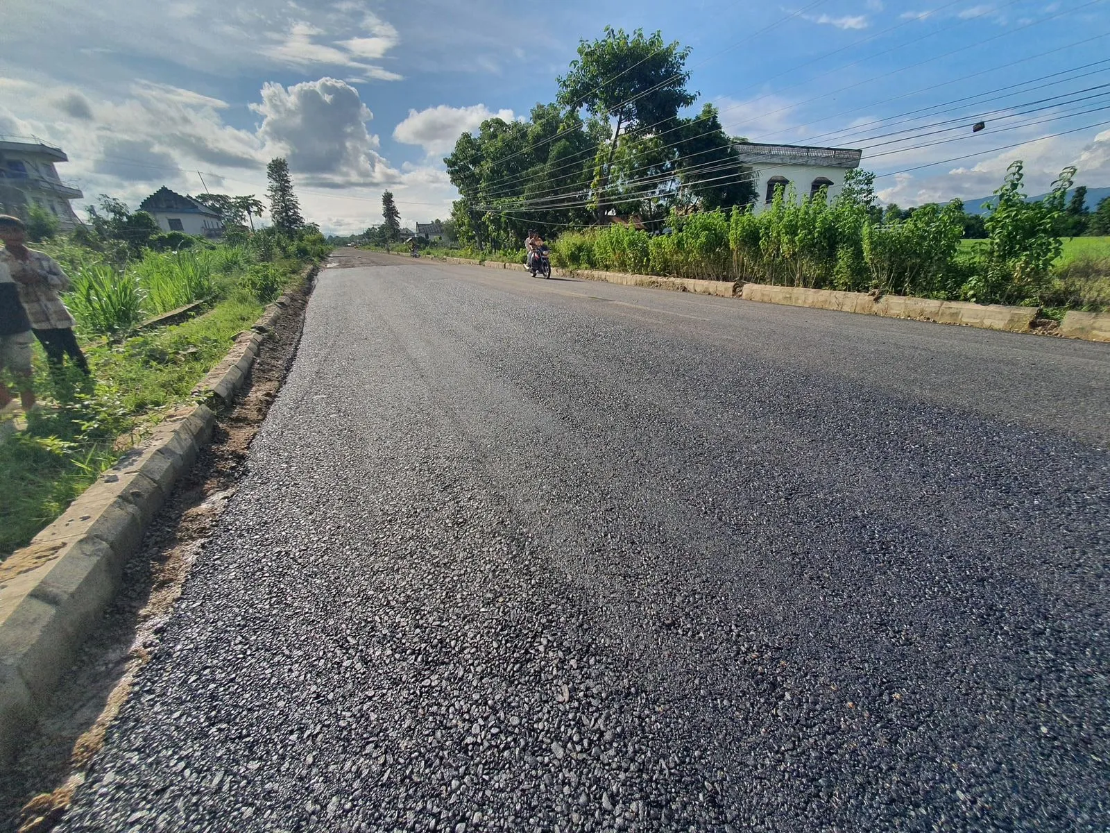 Completed stretch of paved highway running straight into the distance