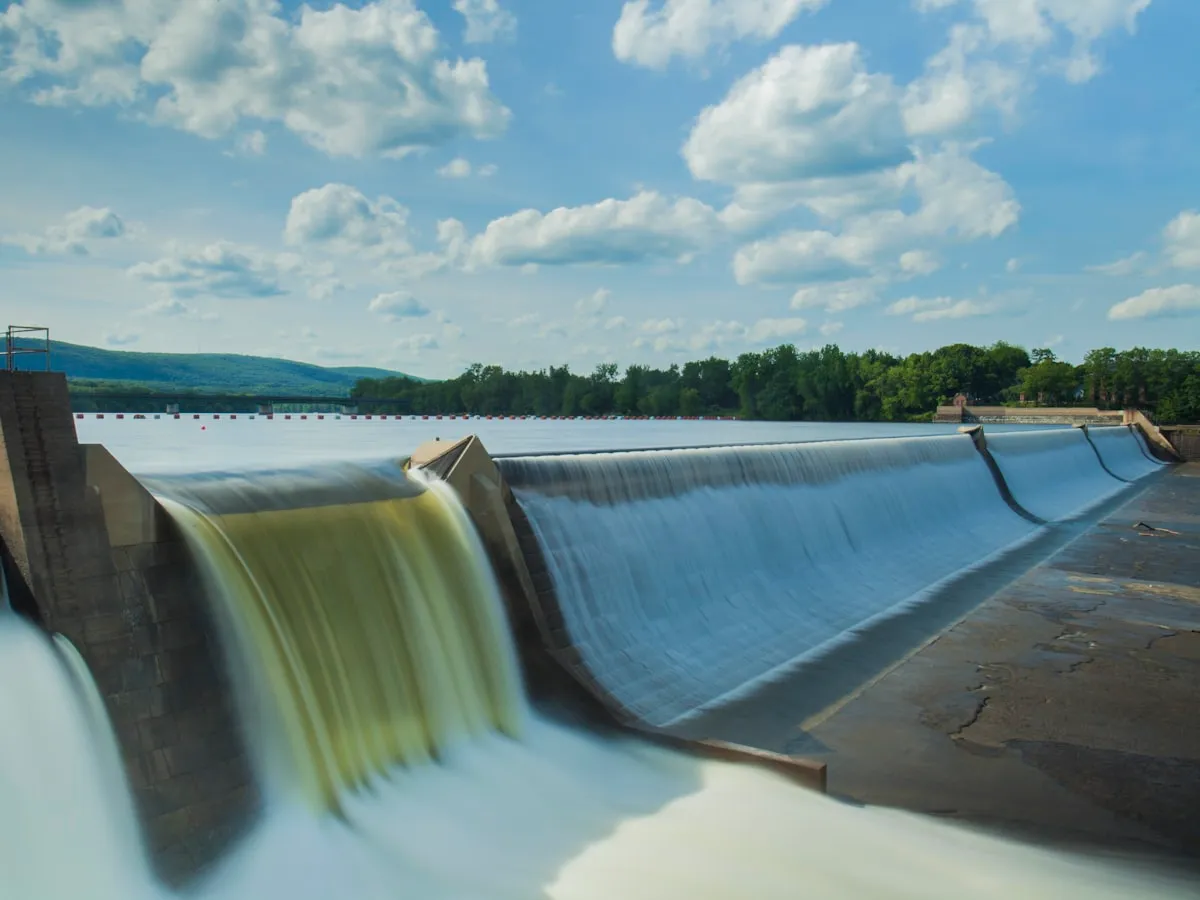 Water flowing over a weir crest on a hydropower intake